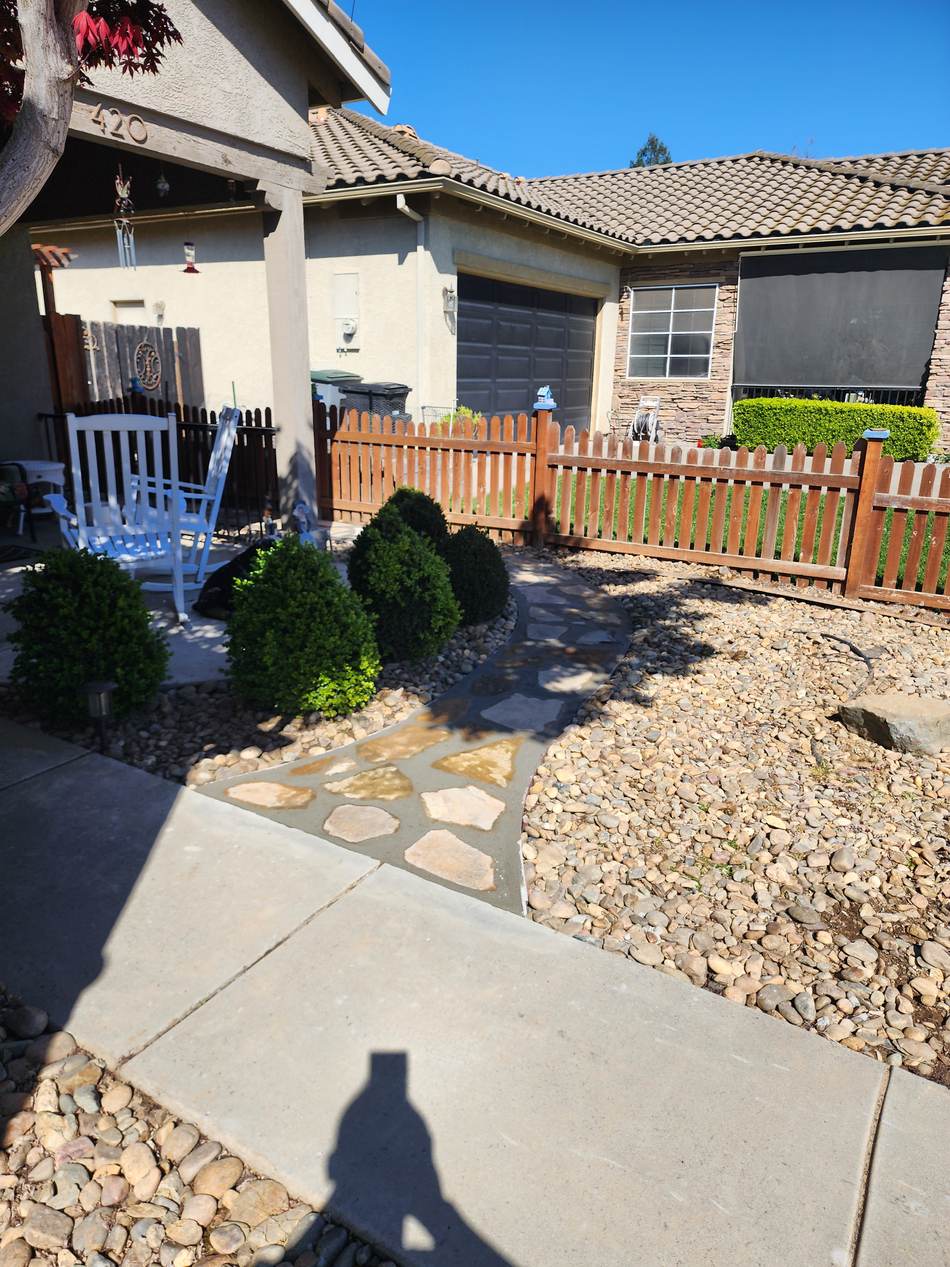 Same curved walkway finished with decorative paver inlays in Escalon